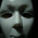 stock-footage-scary-masked-man-over-black-background